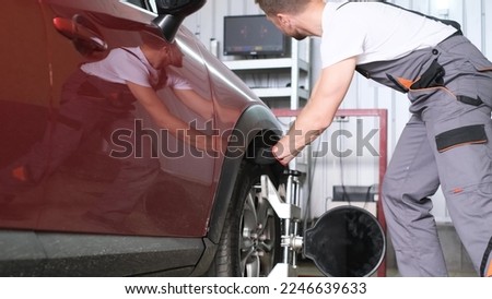 Car Wheels alignment equipment on stand in a repair station. The auto mechanic adjusts the car for diagnostics and settings. Stock photo © 