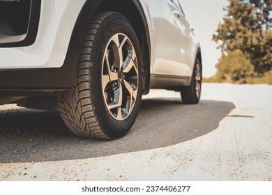 Car wheels close up on a background of asphalt. Car tires. Car wheel close-up. for advertising. - Powered by Shutterstock