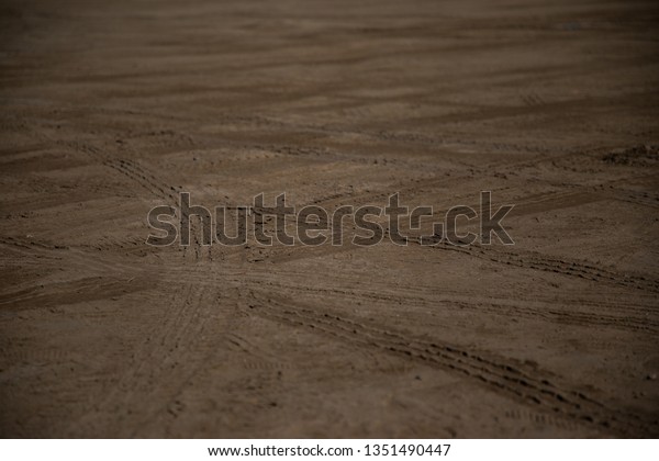 Car wheels marks on\
sand