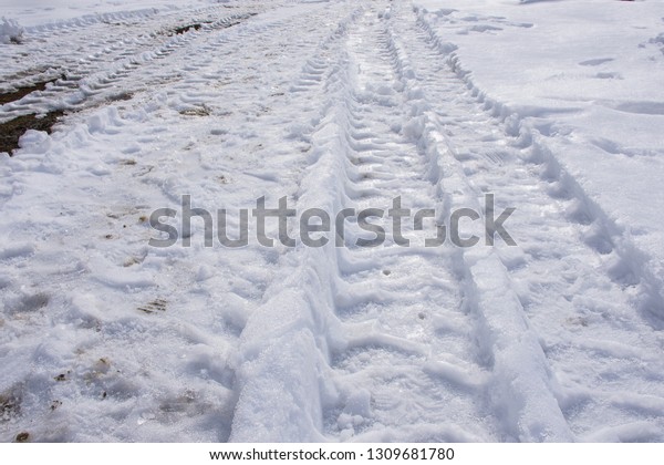 Car wheels prints on snow in winter.copy\
space for text.background