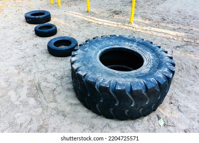 Car Wheels For Sports Training. Rubber Tires Of Different Sizes On The Sports Ground. Foreground