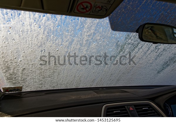 A car window being\
washed at a car wash