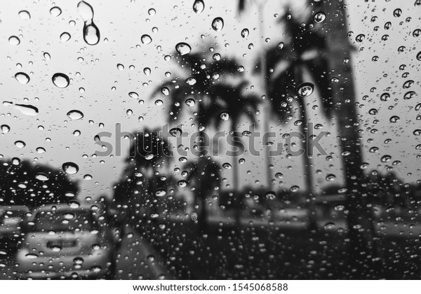 Car window with rain drops. Driving in\
rain. Weather background. Black and white photo rain drops on glass\
sad mood bad weather rainy window\
sadness.