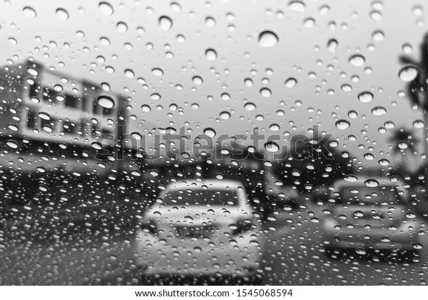 Car window with rain drops. Driving in
rain. Weather background. Black and white photo rain drops on glass
sad mood bad weather rainy window
sadness.