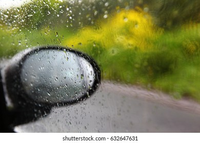 Car Window And Rear View Window With Dripping Rain Water. Torrent. Speed Driving On The Highway