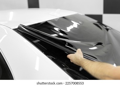 Car window tinting series: Installation of car window tinting. Detailing studio - Shutterstock ID 2257008553