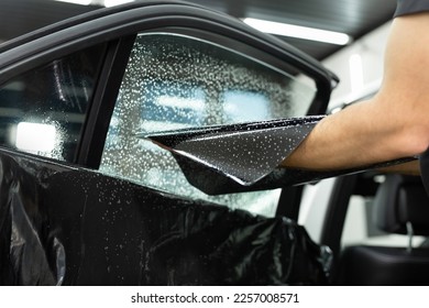 Car window tinting series: Installation of car window tinting. Detailing studio - Shutterstock ID 2257008571