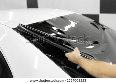 Car window tinting series: Installation of car window tinting. Detailing studio