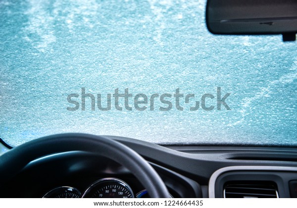 car window under a layer of snow -internal\
look,Winter frozen car\
window