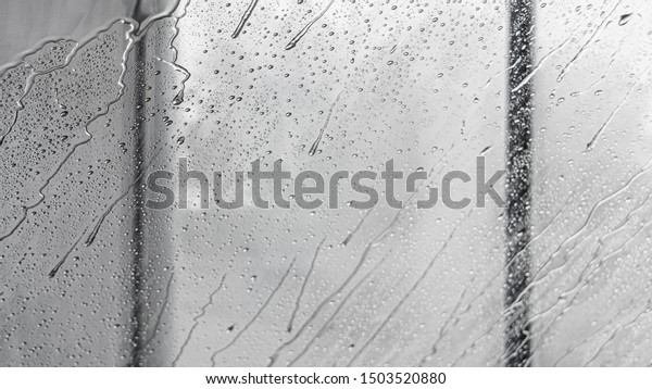 Car window in\
car wash with a lot of\
waterdrops
