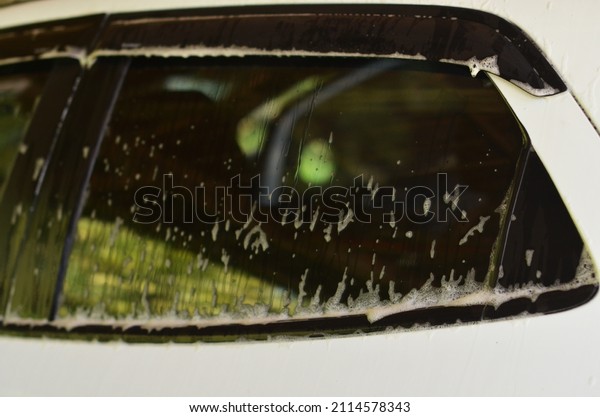 Car window of white\
car with bubble foam
