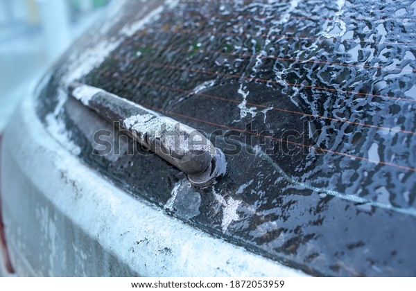 Car\
window and windscreen wiper in ice after freezing rain. Freezing\
rain, anomalies of nature. Soft focus\
technique
