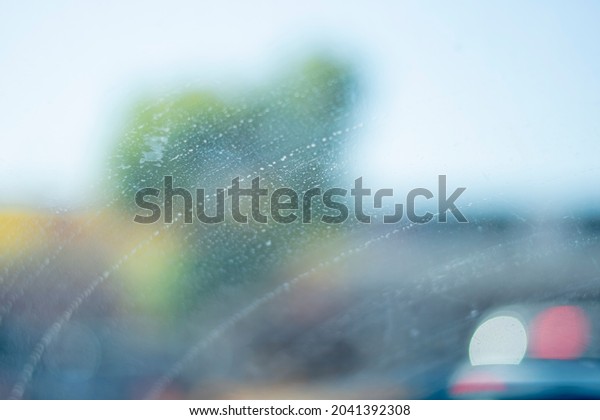 Car\
windshield with a period of water in a\
line