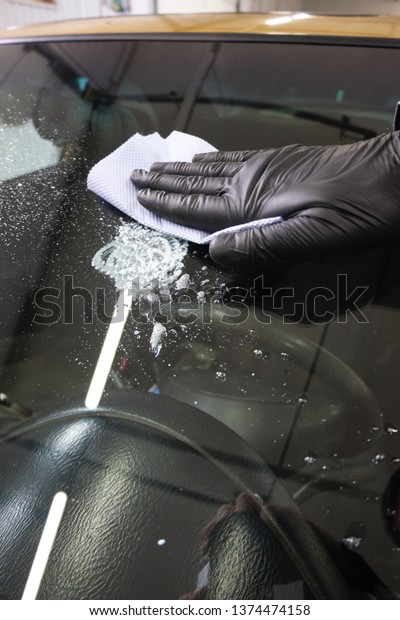car windshield repair in the service station —\
clean the glass