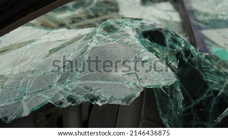 Вroken  car windshield . Shattered window surface with cracks all over. Car accident concept