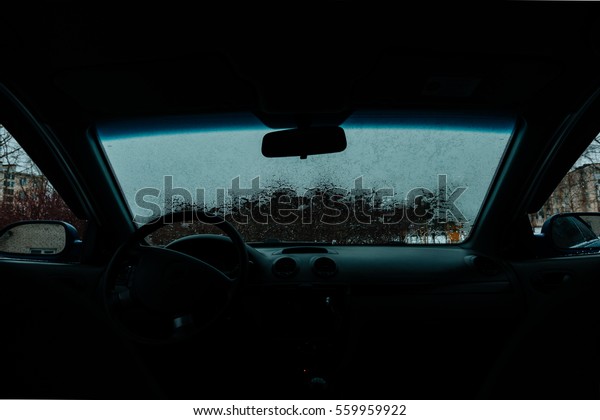 Car Windshield thawed Snow\
Thawing On A Windshield Of A Car view from the passenger\
compartment