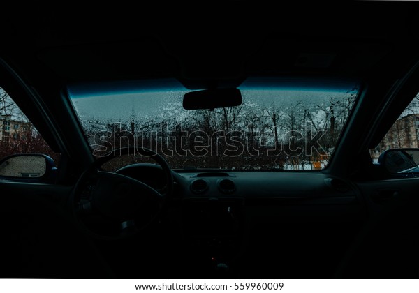 Car Windshield thawed Snow\
Thawing On A Windshield Of A Car view from the passenger\
compartment