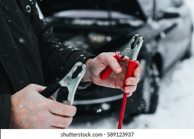 Car, Winter, People And Vehicle Concept - Closeup Of Man Pushing Car Stuck In Snow