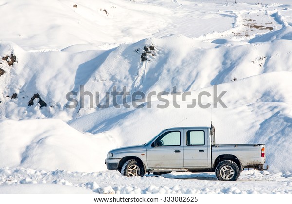 car in winter scenario with marks on the road\
suggesting off road capabilities tour drive car white front danger\
romania snow winter travel season engine detail abstract technology\
metal view model pe