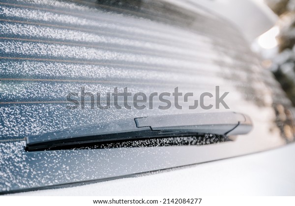 car\
wiper blade in winter at a shallow depth of\
field