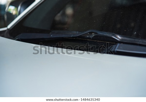 Car\
wiper of car parked on street sunlight\
background