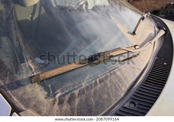 car wipers on a dirty windshield, the appearance of\
the car.