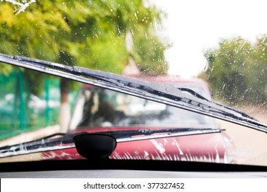 Car wipers wash windshield when driving in rain
