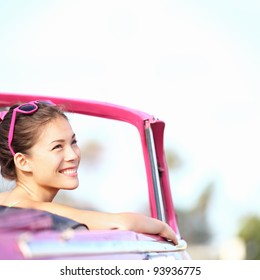 Car Woman Smiling Happy Enjoying Car Road Trip Travel Vacation. Young Retro Woman In Pink Vintage Convertible Car Looking To Side. Beautiful Young Multiracial Caucasian / Chinese Asian In Havana, Cuba