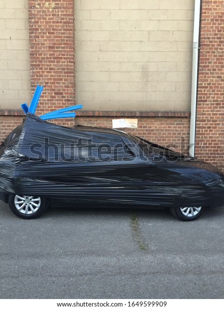 Car\
wrapped in plastic so not to be able to recognise\
car