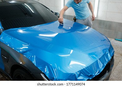 Car Wrapping, Man With Squeegee Installs Film