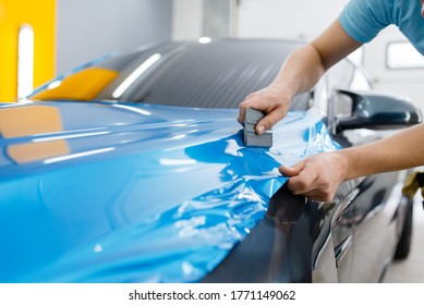 Car Wrapping, Mechanic With Squeegee Installs Film