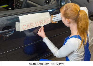 Car Wrapping Professional Puts Letters Made Of Vinyl Foil Or Film On Vehicle Door