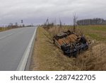 car wreck lying in a roadside ditch

