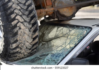 Car Wreck With Truck Tires On Windshield Of Small Destruction Crash