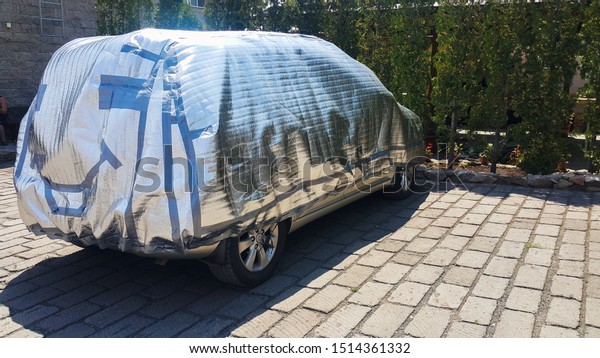 the car is in the yard to shelter from the sun and\
rain, it covers the silver tent on the back of the tent painted\
smiley, car care