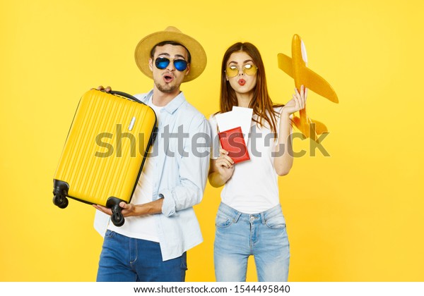 A car with a yellow suitcase and a woman with a\
toy airplane and a passport