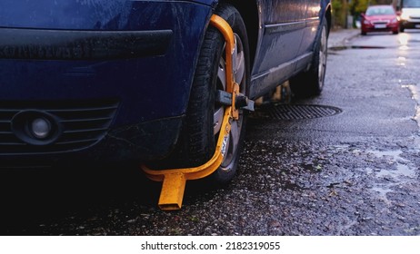 Car With Yellow Wheel Lock Deployed For Illegal Parking