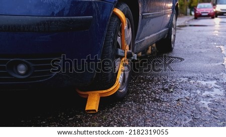 Car with Yellow Wheel Lock Deployed for Illegal Parking
