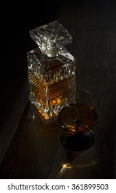 Carafe And Glass With Armenian Cognac On Wooden Table