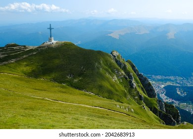 Caraiman Cross and Busteni city in the background, the tallest summit cross in the world situated at such an altitude, Caraiman Peak in Bucegi mountains, Prahova, Romania