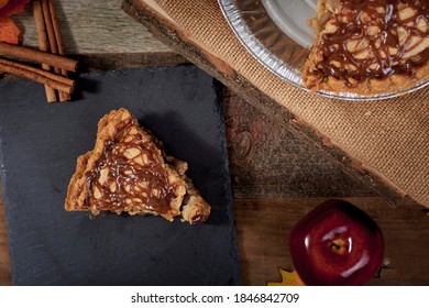 Caramel Apple Pie Slice With Full Pie Close In A Top Down Overhead Rustic Fall Themed Setting