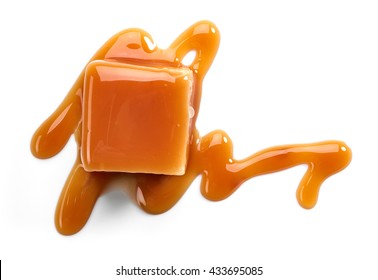 caramel candies and sauce isolated on white background, top view