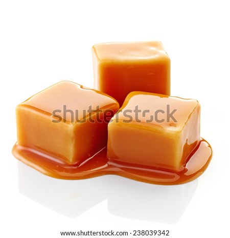 caramel candies and caramel sauce isolated on a white background