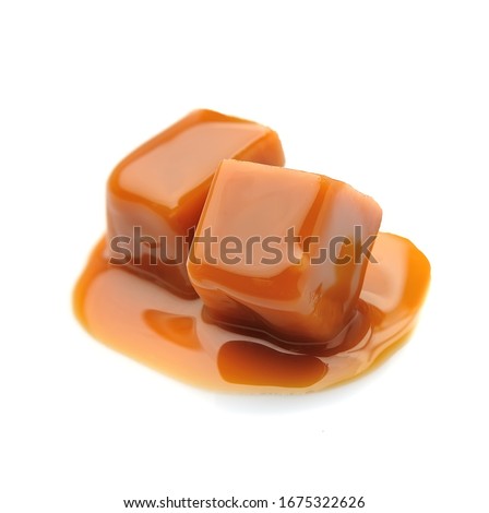 Caramel candies and caramel topping isolated on a white background.