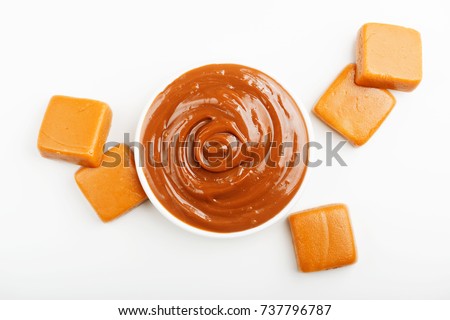 Caramel candies and caramel topping  on a white background.