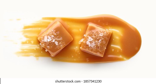 Caramel candy with salt and sweet sauce top view isolated on white background