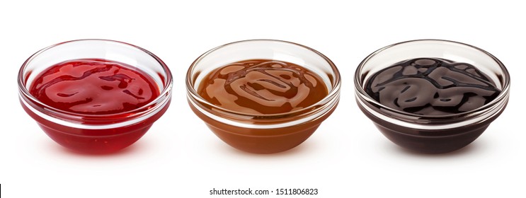 Caramel, chocolate sauces and red berry jam in glass bowls isolated on white background with clipping path, collection of sweet toppings for baking and ice cream - Shutterstock ID 1511806823