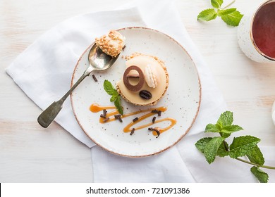 Caramel Coffee Cake In A Glaze With Nuts On Plate Over White Background, Top View