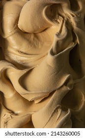 Caramel flavored gelato - full frame detail. Close up of a creamy caramel surface texture of ice cream