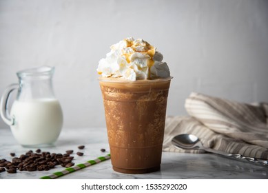 caramel frappe with wipped cream on marble table 